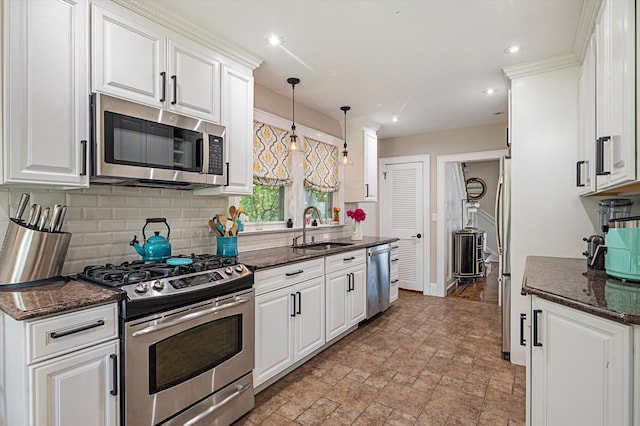 344 N Forest Ave, Rockville Centre, NY 11570 - kitchen featuring appliances with stainless steel finishes, a sink, decorative backsplash, white cabinets, and light stone finish flooring