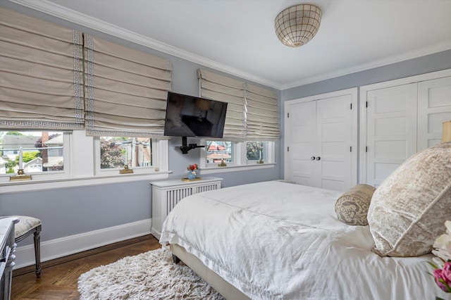 344 N Forest Ave, Rockville Centre, NY 11570 - bedroom with baseboards, crown molding, and two closets