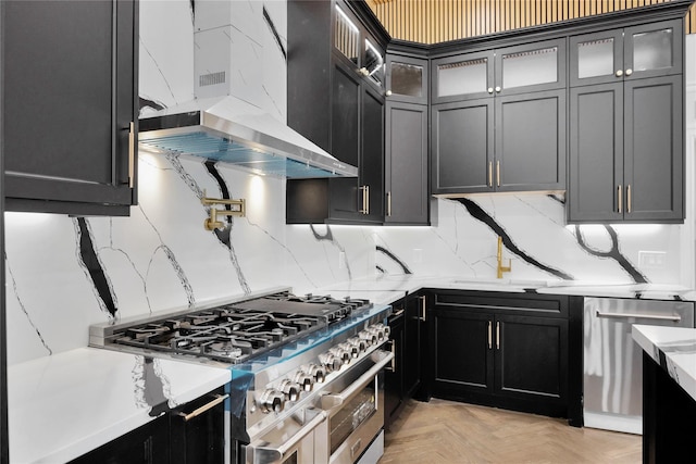 23 Vinton St, Long Beach, NY 11561 - kitchen with stainless steel appliances, exhaust hood, dark cabinetry, and glass insert cabinets