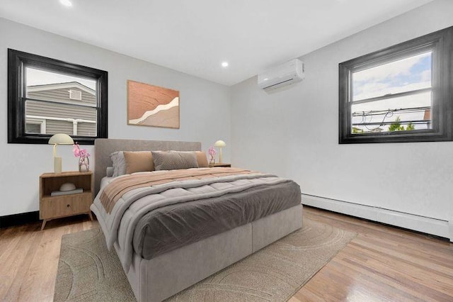 23 Vinton St, Long Beach, NY 11561 - bedroom featuring a wall mounted AC, a baseboard radiator, light wood-type flooring, multiple windows, and recessed lighting