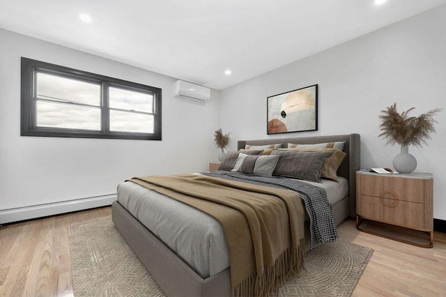 23 Vinton St, Long Beach, NY 11561 - bedroom with an AC wall unit, light wood finished floors, a baseboard radiator, and recessed lighting