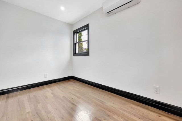 23 Vinton St, Long Beach, NY 11561 - unfurnished room with an AC wall unit, wood finished floors, baseboards, and recessed lighting