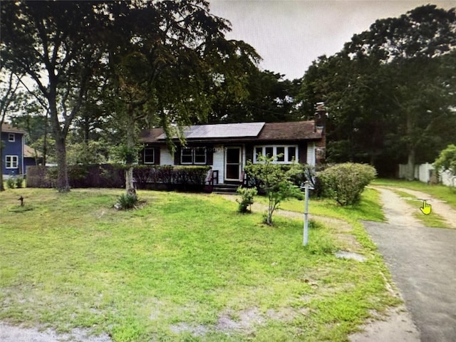 55 Port St, Riverhead, NY 11901 - view of front of home with a chimney and driveway