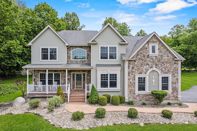 22 Restorative Ln, Middletown, NY 10940 - traditional-style home with stone siding, covered porch, and roof with shingles