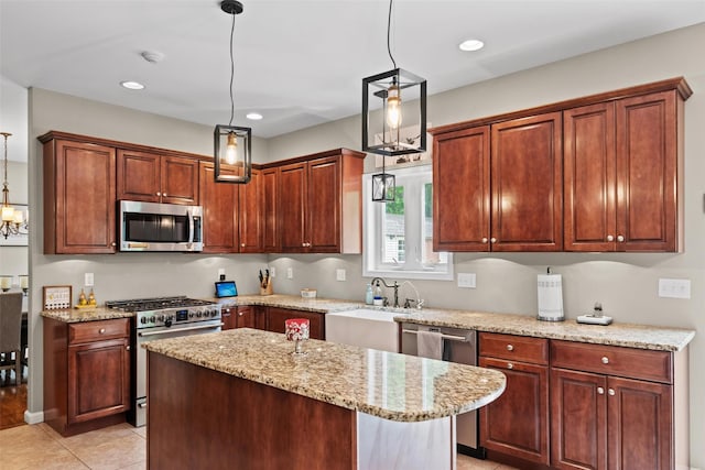 22 Restorative Ln, Middletown, NY 10940 - kitchen featuring stainless steel appliances, light tile patterned floors, hanging light fixtures, light stone countertops, and a center island