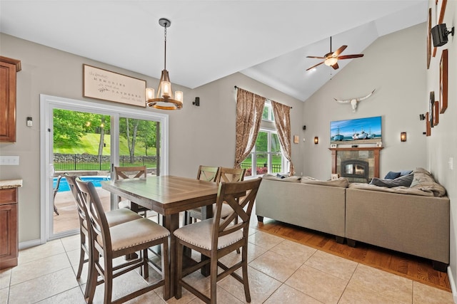 22 Restorative Ln, Middletown, NY 10940 - dining room featuring lofted ceiling, light tile patterned floors, a glass covered fireplace, a ceiling fan, and a chandelier