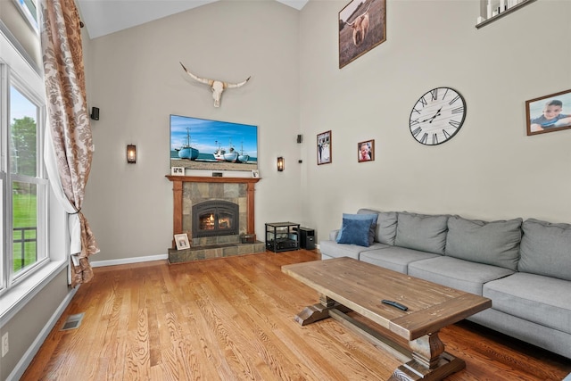 22 Restorative Ln, Middletown, NY 10940 - living area featuring wood finished floors, a tiled fireplace, high vaulted ceiling, and baseboards