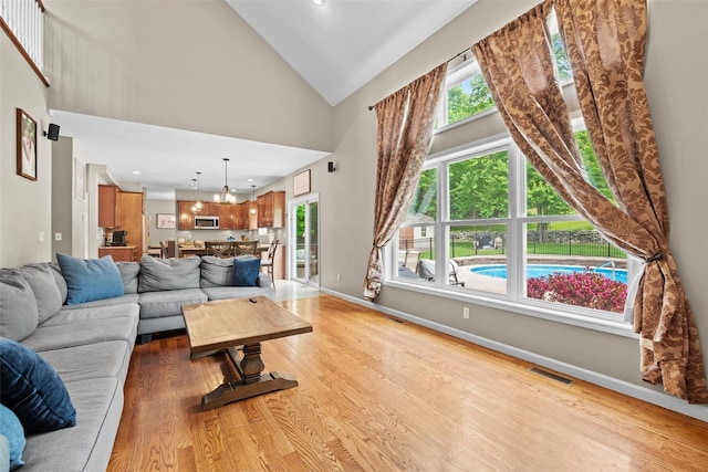 22 Restorative Ln, Middletown, NY 10940 - living room with high vaulted ceiling, light wood-style floors, baseboards, a chandelier, and recessed lighting