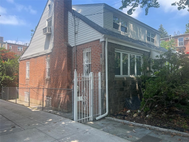 2449 Young Ave, Bronx, NY 10469 - view of side of property with a chimney, brick siding, and cooling unit