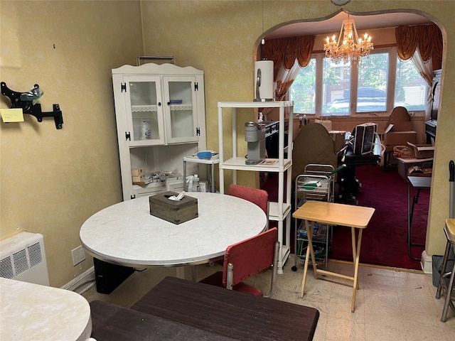 2449 Young Ave, Bronx, NY 10469 - dining space with arched walkways, a chandelier, and radiator