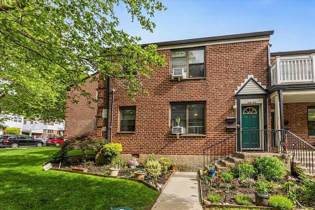 196-66 67th Ave Unit 1Fl, Fresh Meadows, NY 11365 - view of front of home with brick siding, a front lawn, and cooling unit
