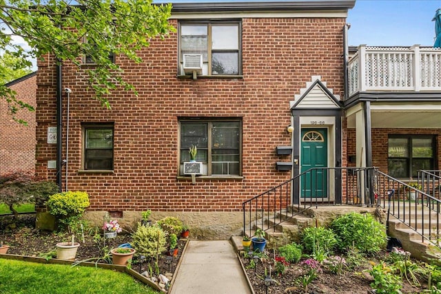 196-66 67th Ave Unit 1Fl, Fresh Meadows, NY 11365 - view of front of home featuring brick siding, a balcony, and cooling unit