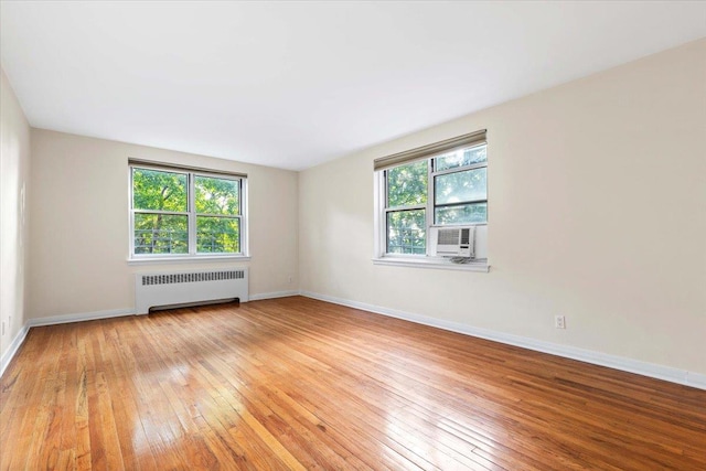 280 Collins Ave Unit 6J, Mount Vernon, NY 10552 - spare room featuring radiator, light wood-type flooring, cooling unit, and baseboards