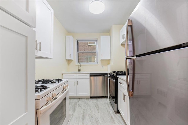 280 Collins Ave Unit 6J, Mount Vernon, NY 10552 - kitchen with appliances with stainless steel finishes, a sink, white cabinetry, and light countertops