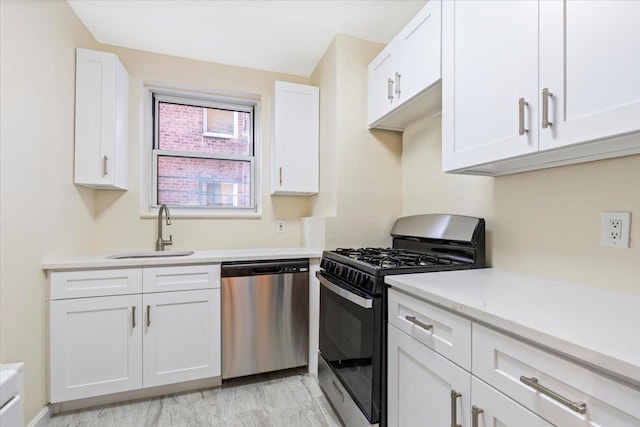 280 Collins Ave Unit 6J, Mount Vernon, NY 10552 - kitchen with stainless steel appliances, a sink, white cabinets, and light stone countertops