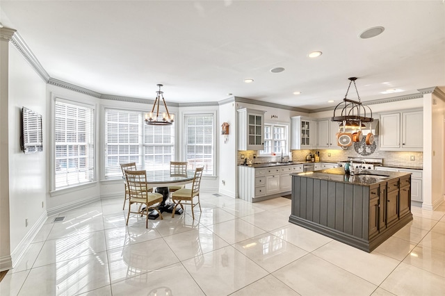 9 Stream Ct, Great Neck, NY 11024 - kitchen featuring a chandelier, baseboards, tasteful backsplash, ornamental molding, and healthy amount of natural light