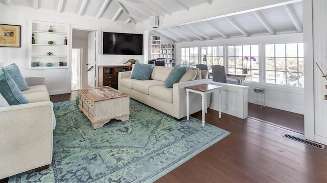 234 Dune Rd, Quogue, NY 11959 - living area featuring plenty of natural light, dark wood finished floors, and built in shelves