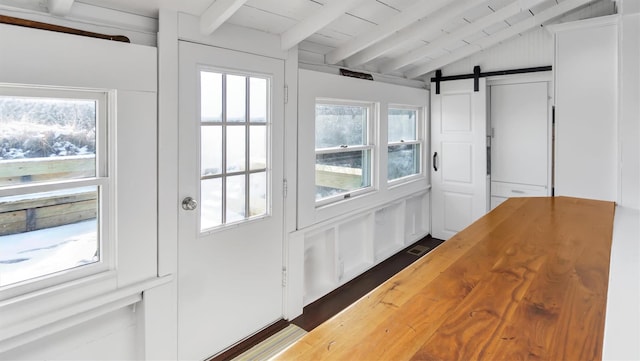 234 Dune Rd, Quogue, NY 11959 - entryway featuring a barn door, dark wood-style floors, and wooden ceiling