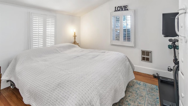 234 Dune Rd, Quogue, NY 11959 - bedroom featuring wood finished floors, lofted ceiling, heating unit, and baseboards