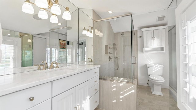234 Dune Rd, Quogue, NY 11959 - bathroom featuring toilet, a stall shower, vanity, a chandelier, and plenty of natural light