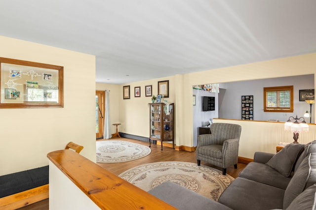 1 Chuck Ln, Selden, NY 11784 - living room featuring wood finished floors, a baseboard heating unit, and baseboards