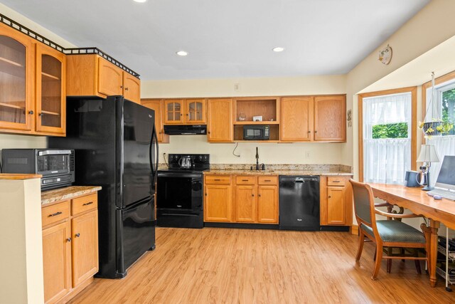 1 Chuck Ln, Selden, NY 11784 - kitchen featuring black appliances, under cabinet range hood, light wood-type flooring, glass insert cabinets, and open shelves