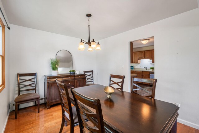 67 Keats Dr, New Windsor, NY 12553 - dining area featuring light wood finished floors, baseboard heating, a chandelier, and baseboards