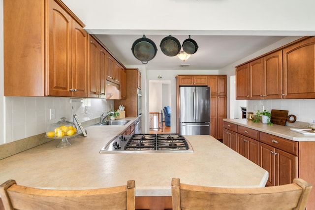 67 Keats Dr, New Windsor, NY 12553 - kitchen with stainless steel appliances, a sink, a peninsula, light countertops, and backsplash