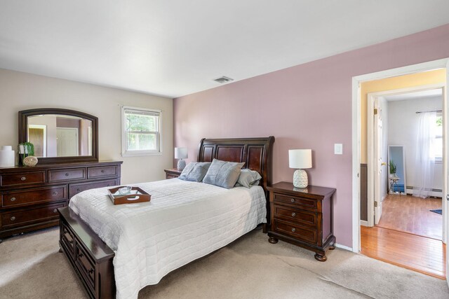 67 Keats Dr, New Windsor, NY 12553 - bedroom with baseboard heating, light carpet, and baseboards
