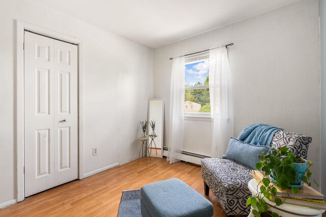 67 Keats Dr, New Windsor, NY 12553 - sitting room with a baseboard heating unit, light wood-type flooring, and baseboards