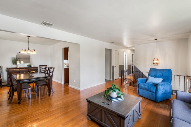 67 Keats Dr, New Windsor, NY 12553 - living room with a chandelier, light wood-style floors, and baseboards