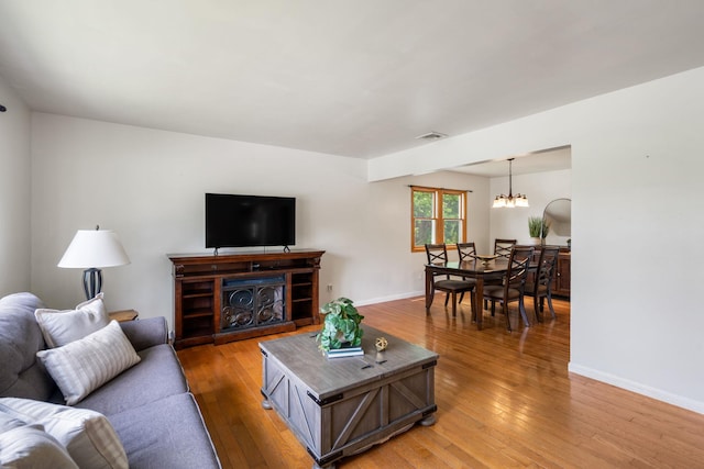 67 Keats Dr, New Windsor, NY 12553 - living room featuring light wood-type flooring, a chandelier, and baseboards