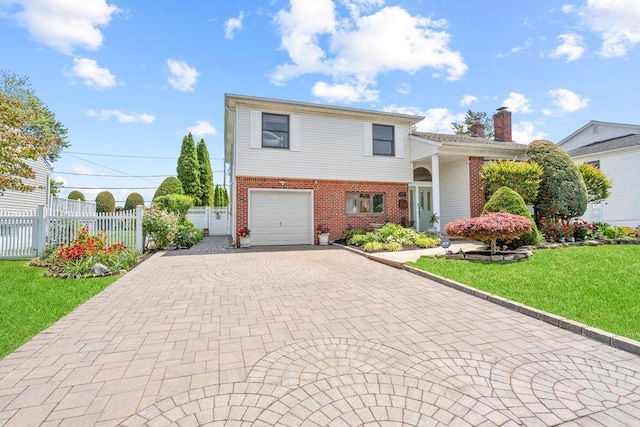 129 Colony Ln, Syosset, NY 11791 - tri-level home featuring brick siding, decorative driveway, a garage, and a chimney