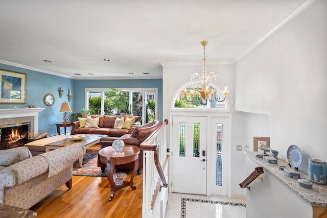 129 Colony Ln, Syosset, NY 11791 - entrance foyer with a lit fireplace, crown molding, a chandelier, recessed lighting, and light tile patterned floors