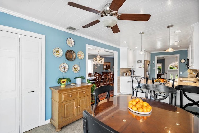 129 Colony Ln, Syosset, NY 11791 - dining space with a ceiling fan, light tile patterned flooring, a chandelier, and ornamental molding
