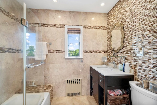 129 Colony Ln, Syosset, NY 11791 - full bath featuring radiator, tile walls, vanity, toilet, and enclosed tub / shower combo