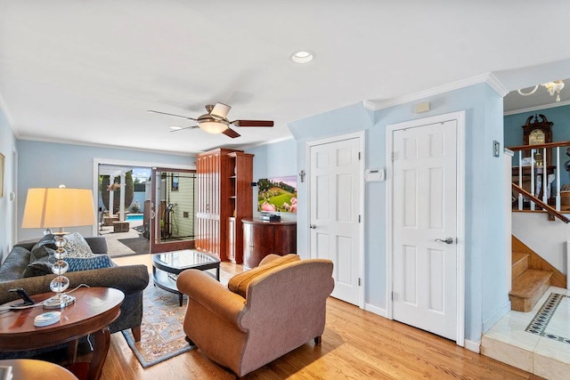 129 Colony Ln, Syosset, NY 11791 - living room featuring crown molding, stairs, ceiling fan, light wood-type flooring, and baseboards