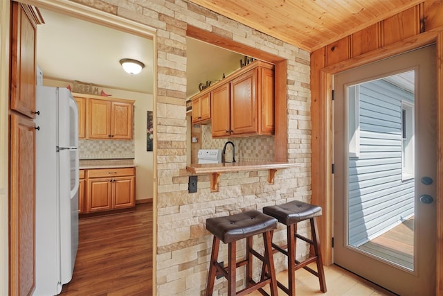 34 Argyle St, Lake Peekskill, NY 10537 - kitchen featuring freestanding refrigerator, light countertops, a kitchen bar, light wood finished floors, and wood ceiling