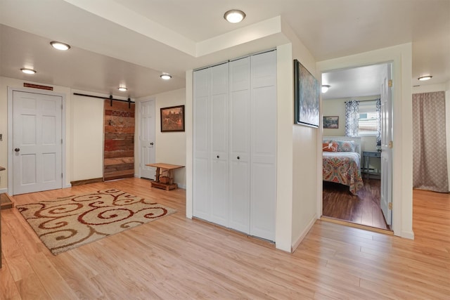 34 Argyle St, Lake Peekskill, NY 10537 - entryway featuring a barn door, light wood-type flooring, and baseboards