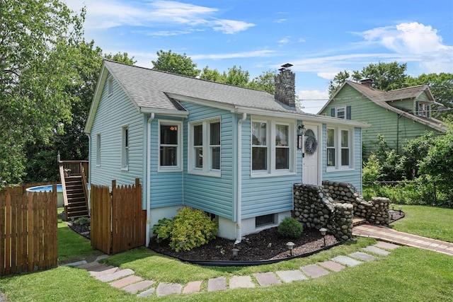 34 Argyle St, Lake Peekskill, NY 10537 - view of front of house with a chimney and roof with shingles