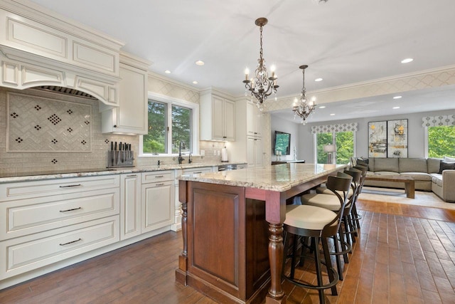 226 Briarwood Dr, Somers, NY 10589 - kitchen featuring black electric stovetop, a chandelier, open floor plan, plenty of natural light, and crown molding
