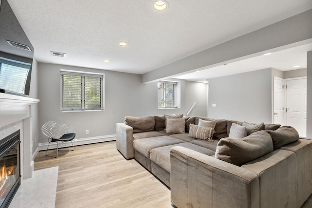 226 Briarwood Dr, Somers, NY 10589 - living area featuring recessed lighting, light wood finished floors, a fireplace with flush hearth, and a baseboard radiator
