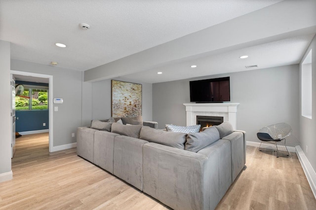 226 Briarwood Dr, Somers, NY 10589 - living room with light wood-type flooring, a lit fireplace, and recessed lighting