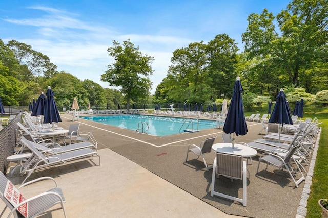 226 Briarwood Dr, Somers, NY 10589 - community pool featuring a patio area and view of wooded area