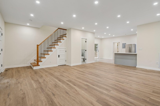 1293 Pulaski Rd, East Northport, NY 11731 - unfurnished living room featuring stairway, light wood-type flooring, baseboards, and recessed lighting