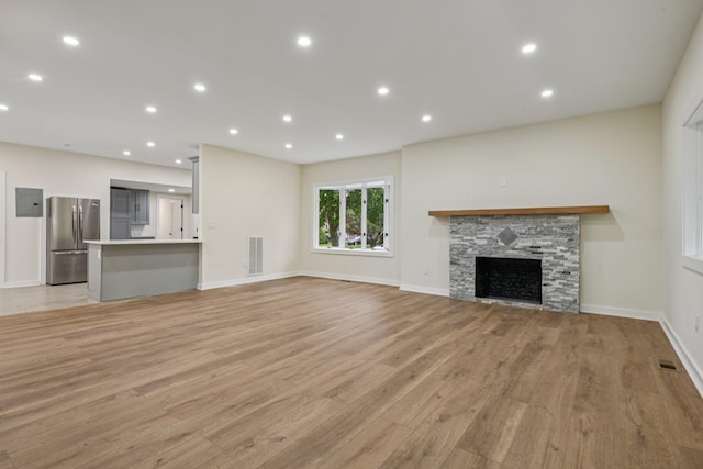 1293 Pulaski Rd, East Northport, NY 11731 - unfurnished living room featuring light wood finished floors, a fireplace, baseboards, and recessed lighting