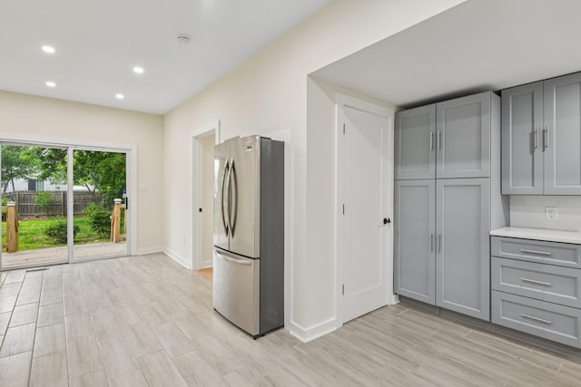 1293 Pulaski Rd, East Northport, NY 11731 - kitchen with freestanding refrigerator, gray cabinets, baseboards, light wood-type flooring, and recessed lighting