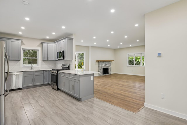 1293 Pulaski Rd, East Northport, NY 11731 - kitchen featuring gray cabinetry, appliances with stainless steel finishes, light wood-style flooring, recessed lighting, and baseboards