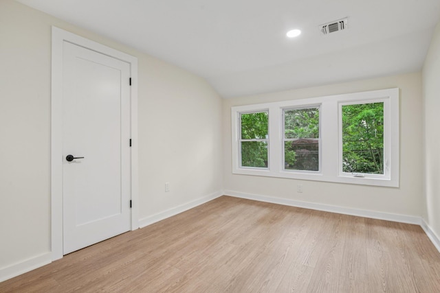 1293 Pulaski Rd, East Northport, NY 11731 - empty room featuring wood finished floors, baseboards, and lofted ceiling