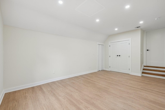 1293 Pulaski Rd, East Northport, NY 11731 - empty room with light wood-style floors, recessed lighting, baseboards, vaulted ceiling, and a smoke detector